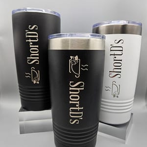 ShortD's 20 oz stainless steel tumbler featuring the signature logo, designed for keeping coffee hot or cold on the go.